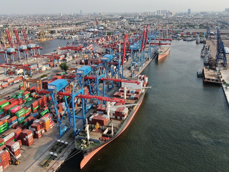 Busy shipping port with cranes and cargo containers
